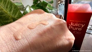 close up detail of juicy pure water-based lube shimmering in the sunlight on the back of a hand to demonstrate safety for sensitive skin