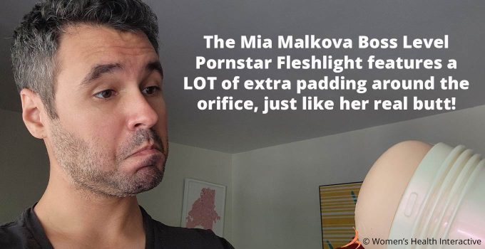 photograph of justin looking at the pornstar fleshlight in his hand with text overlay that reads: the mia malkova boss level pornstar fleshlight features a lot of extra padding around the orifice, just like her real butt