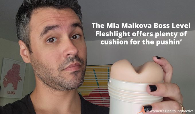 photograph of justin holding the mia malkova boss level fleshlight to display its padded orifice with text overlay that reads: the mia malkova boss level anal fleshlight offers plenty of cushion for the pushin'