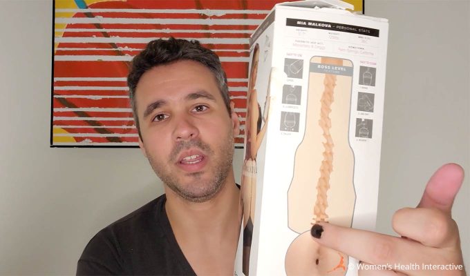 photograph of tester justin holding the box for the mia malkova boss level anal pornstar fleshlight to display the texture graphic on the back and its curved design