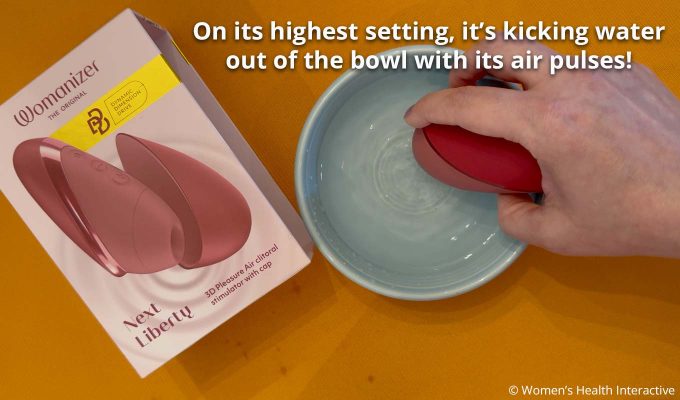 womanizer next liberty demonstrated in water with text explaining that the air pulses are so strong they're kicking water out of the bowl