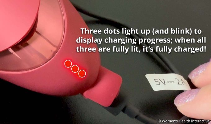 closeup detail of the three charging lights on the womanizer next liberty demonstrating charging progress