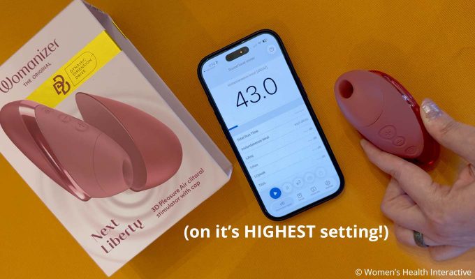 womanizer next liberty next to phone screen display with decibel reading 43dB at the vibrator's highest setting