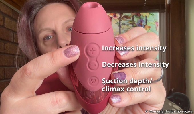 product tester alison showing the button detail on the womanizer next liberty to control intensity and suction depth