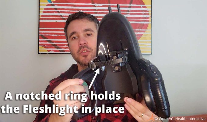 photograph of product tester justin holding the fleshlight universal launch to display the notched ring that holds the stroker in place with text overlay that reads: a notched ring holds the fleshlight in place