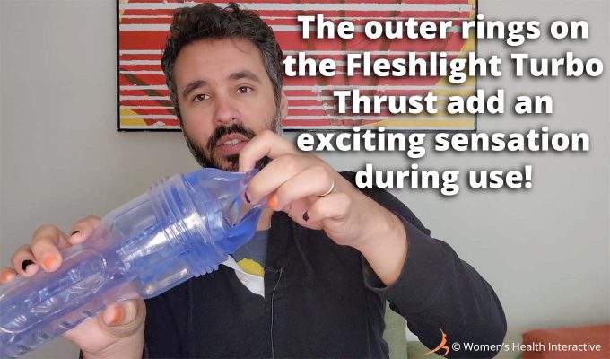 photograph of product tester justin holding the clear and transparent fleshlight turbo thrust ice in his hand with text overlay that reads the outer rings on the fleshlight turbo thrust add exciting sensations during use