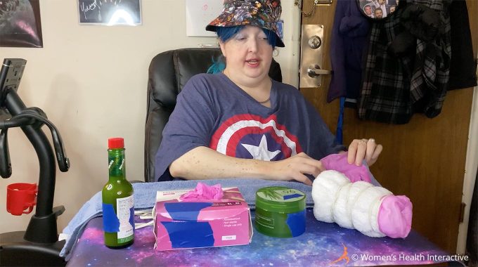 photograph of wednesday starting her diy fleshlight project by placing a glove at one end of the towel