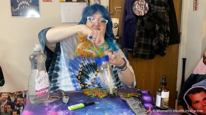 photograph of wednesday pouring aqua beads into her bottle for her diy fleshlight 