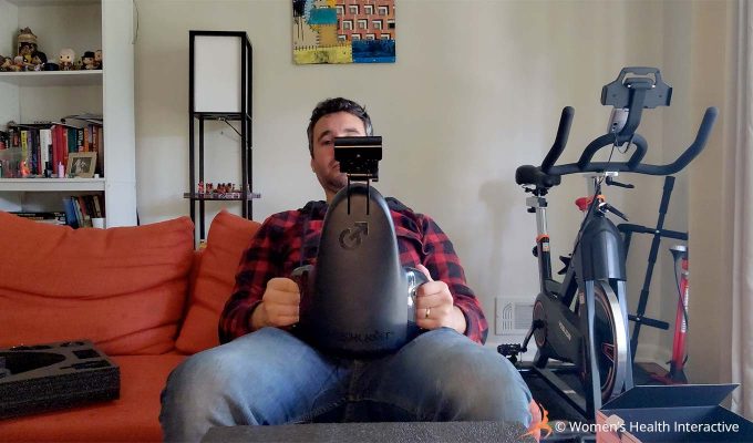 photograph of product tester justin leaning back while holding the fleshlight universal launch automatic masturbator against his clothed pelvis to demonstrate its use and positioning