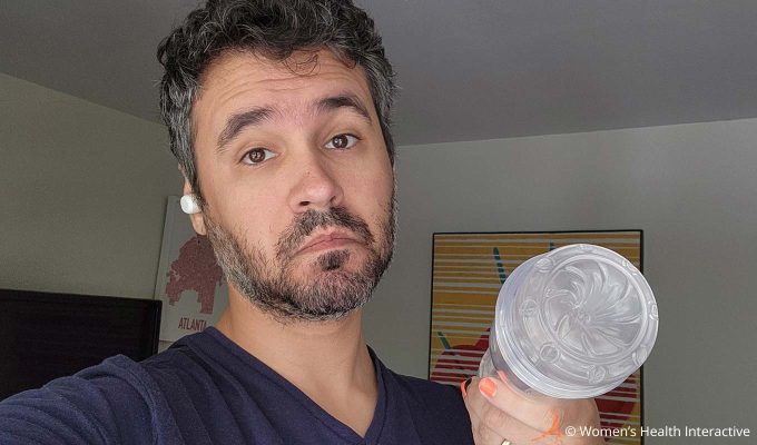 photograph of product tester justin holding the clear transparent fleshlight go torque ice in his hand while making a playful expression on his face