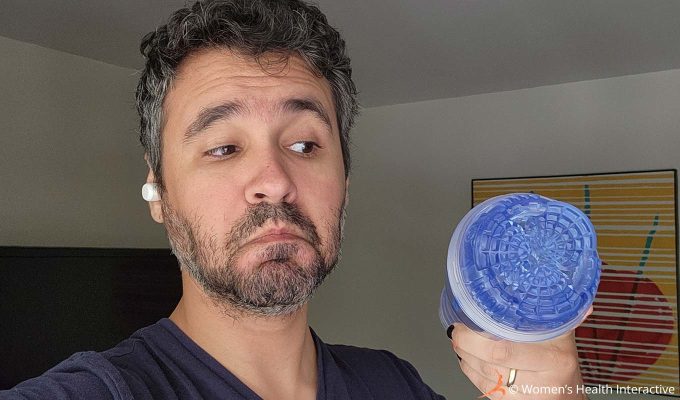photograph of product tester justin holding the clear fleshlight turbo core ice in his hand while making a playful frowny face