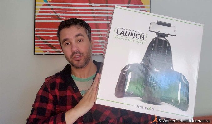 photograph of product tester justin holding the large box containing the fleshlight universal launch with its picture on the viewer-facing side