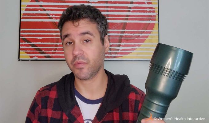 photograph of product tester justin holding the fleshlight vibro butt case in one hand while making an inquisitive expression on his face as though preparing himself for the thought of disassembling it and cleaning it