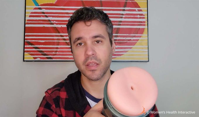 photograph of product tester justin holding the fleshlight vibro butt anal stroker in one hand to display the orifice to the viewer in detail
