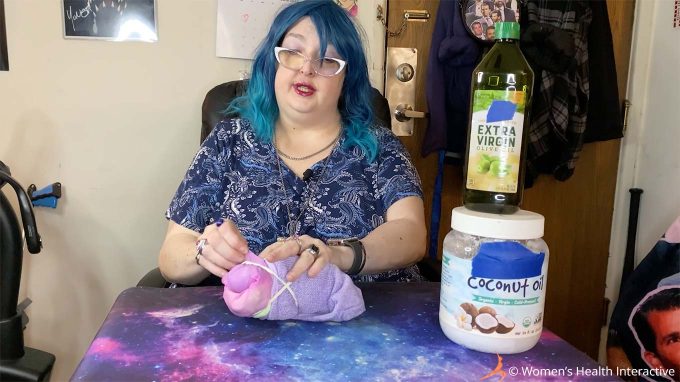 photograph of wednesday securing her diy sock fleshlight with rubber bands