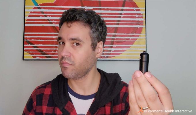photograph of product tester justin holding a single bullet vibrator from the fleshlight vibro lady vibrating pocket pussy while making a playful sideways expression on his face