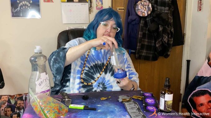 photograph of wednesday pulling a condom through the plastic bottle during her diy fleshlight craft