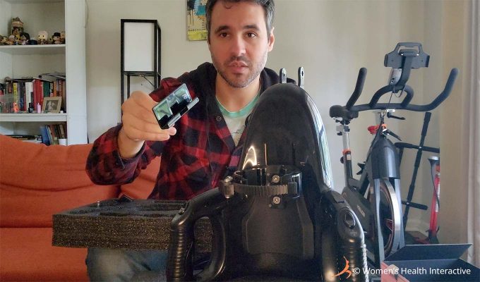 photograph of product tester justin holding one of the smartphone holders in his hand that was included with the fleshlight universal launch automatic masturbator