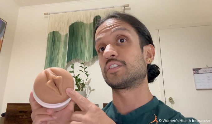 photograph of tester david holding the autumn falls cream vulva fleshlight and pointing to its orifice