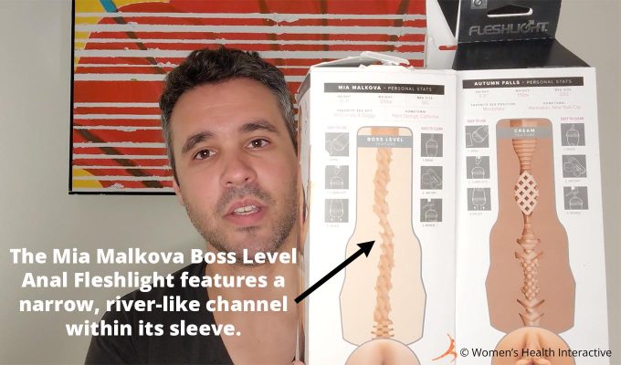 photograph of tester justin holding the boxes for the mia malkova boss level and autumn falls cream fleshlights to compare their texture maps, with text overlay that explains the mia malkova features a narrow river-like channel throughout the sleeve