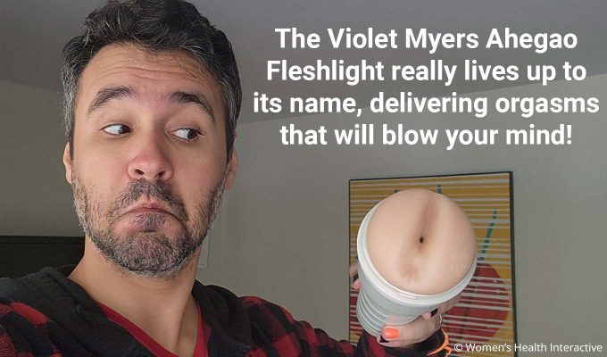photograph of product tester justin holding the violet myers fleshlight while making a playful expression with text overlay that reads: the violet myers ahegao fleshlight really lives up to its name, delivering orgasms that will blow your mind