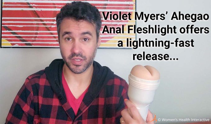 photograph of product tester justin holding the anal violet myers fleshlight in his hand with text overlay that reads: violet myers' ahegao anal fleshlight offers a lightning-fast release