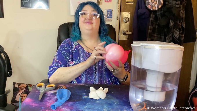photograph of wednesday smiling while holding the balloon fleshlight she made