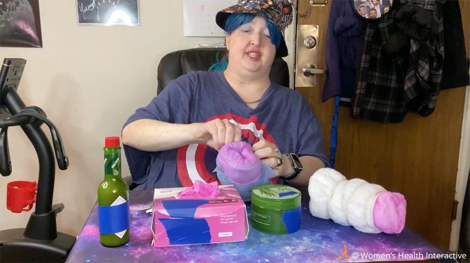 photograph of wednesday folding the ends of the glove over the edge of the rolled towel while making a diy fleshlight