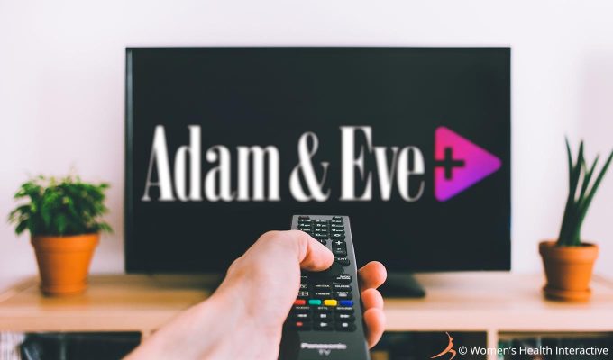 photograph of a hand holding a remote control pointed at a television screen in the distant blurry background with the adam & eve plus logo displayed across the black screen, concept of how the service works