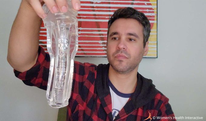 photograph of product tester justin holding a crystal clear fleshlight sleeve in his hand