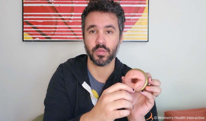 photograph of product tester justin holding the quickshot stu mouth and butt fleshlight with the mouth facing the viewer