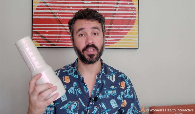 photograph of justin holding a white fleshlight case in his hand