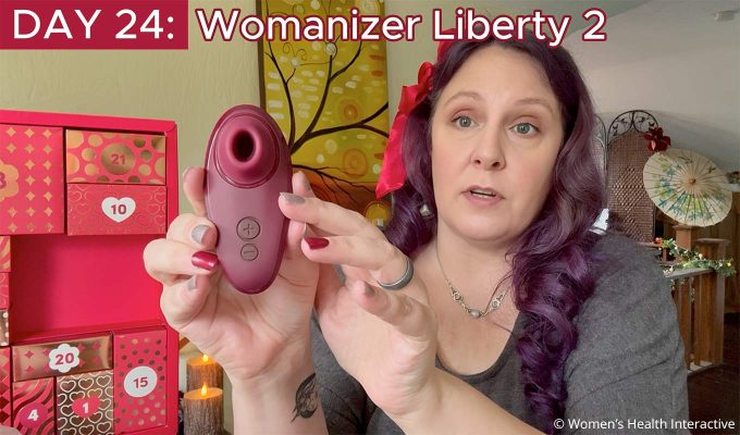 product tester alison holding the womanizer liberty 2 clit sucking vibrator that comes on the last day of the 2026 lovehoney couples calendar
